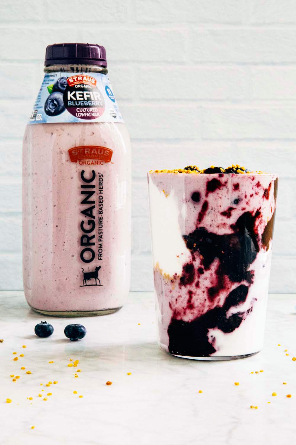 blended Blueberry Coconut Kefir Smoothie smoothie in a glass next to straus organic blueberry kefir
